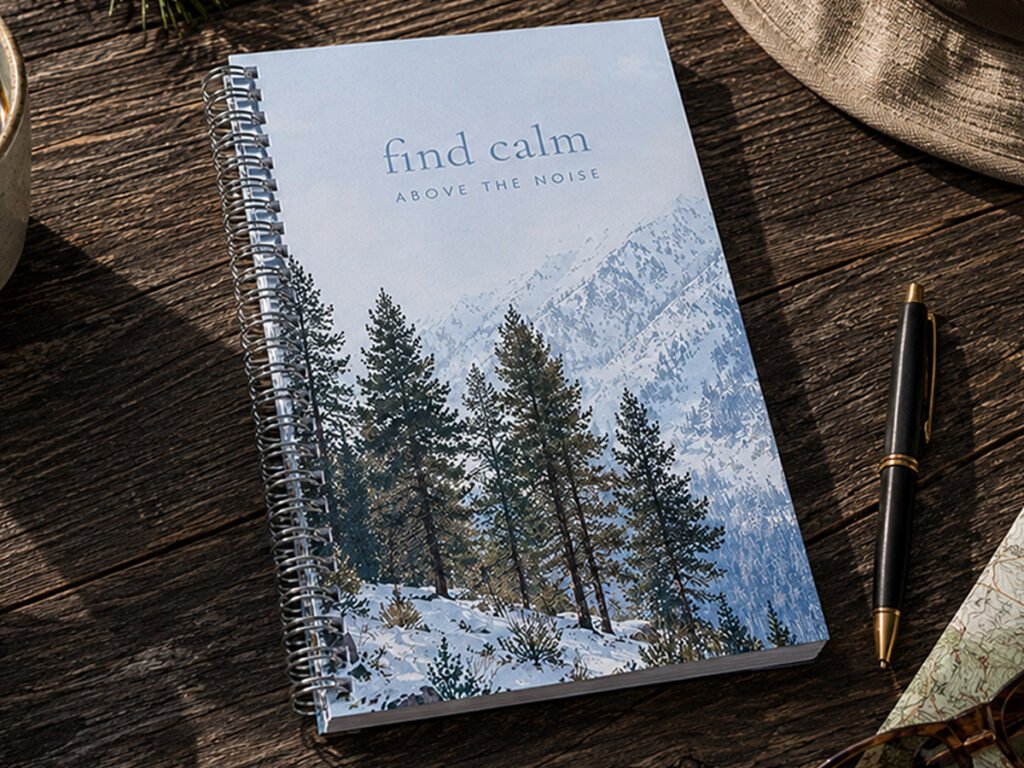 Tahoe snowy mountains notebook with pine trees and Sierra Nevada mountain landscape on a rustic wood table