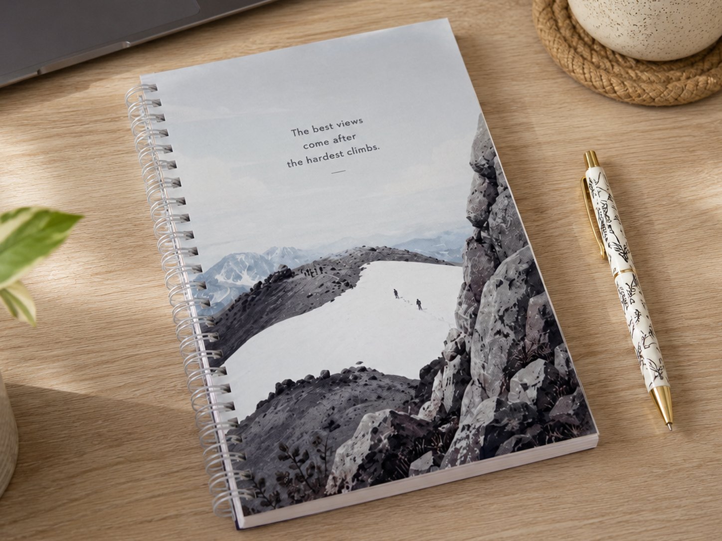 Lassen hikers notebook with mountain cover on a wooden desk beside a pen
